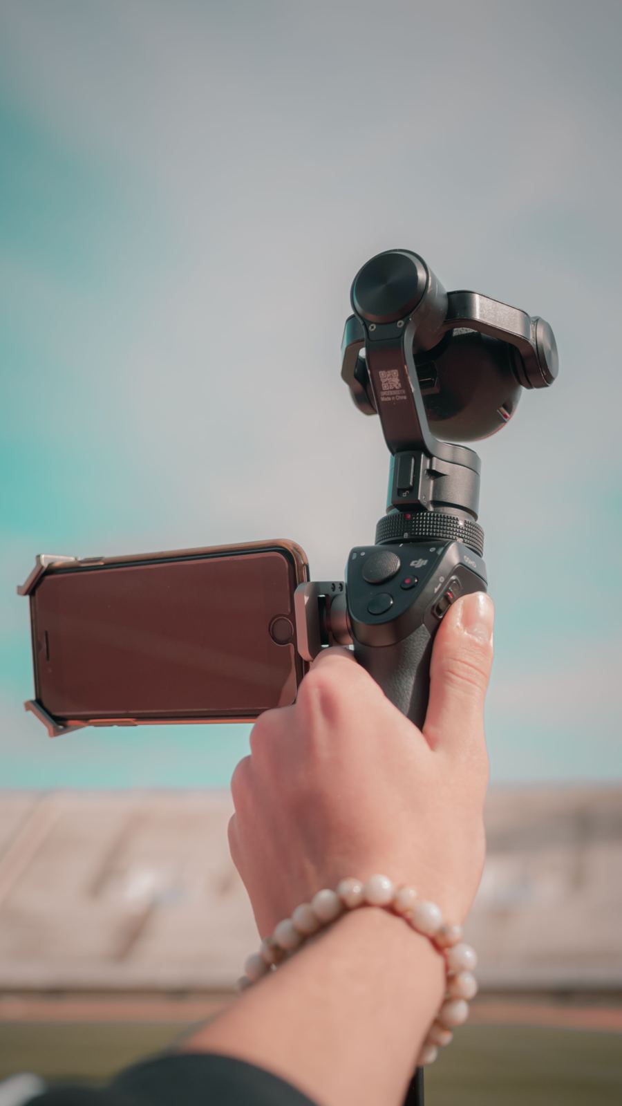 A phone on a gimbal held up at a stadium