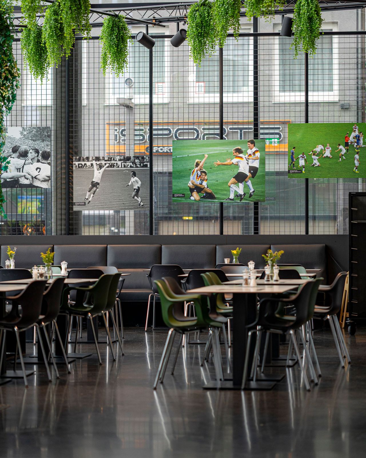 A sports lounge with booth seating and match photography