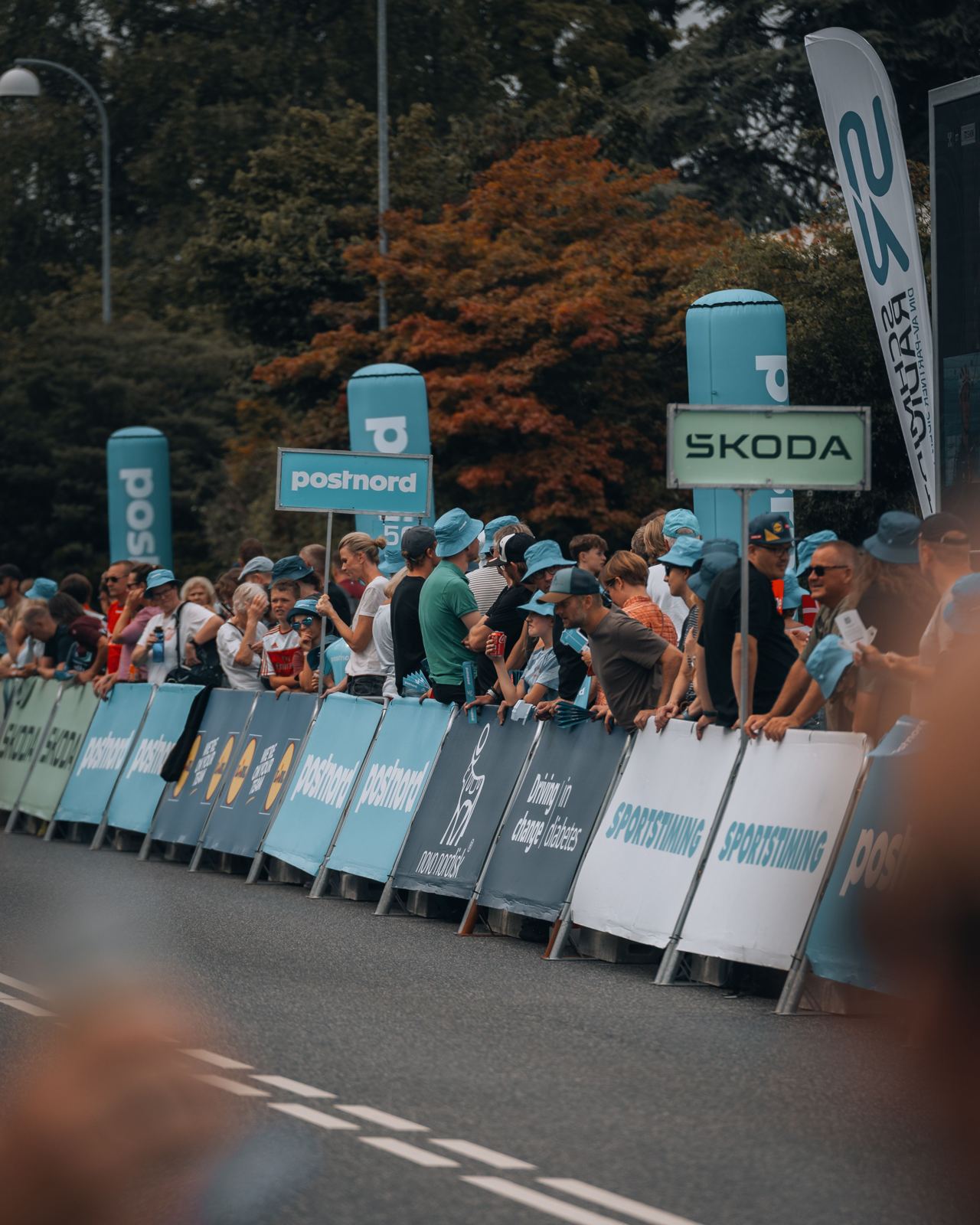 Fans lining sponsor boards at a race