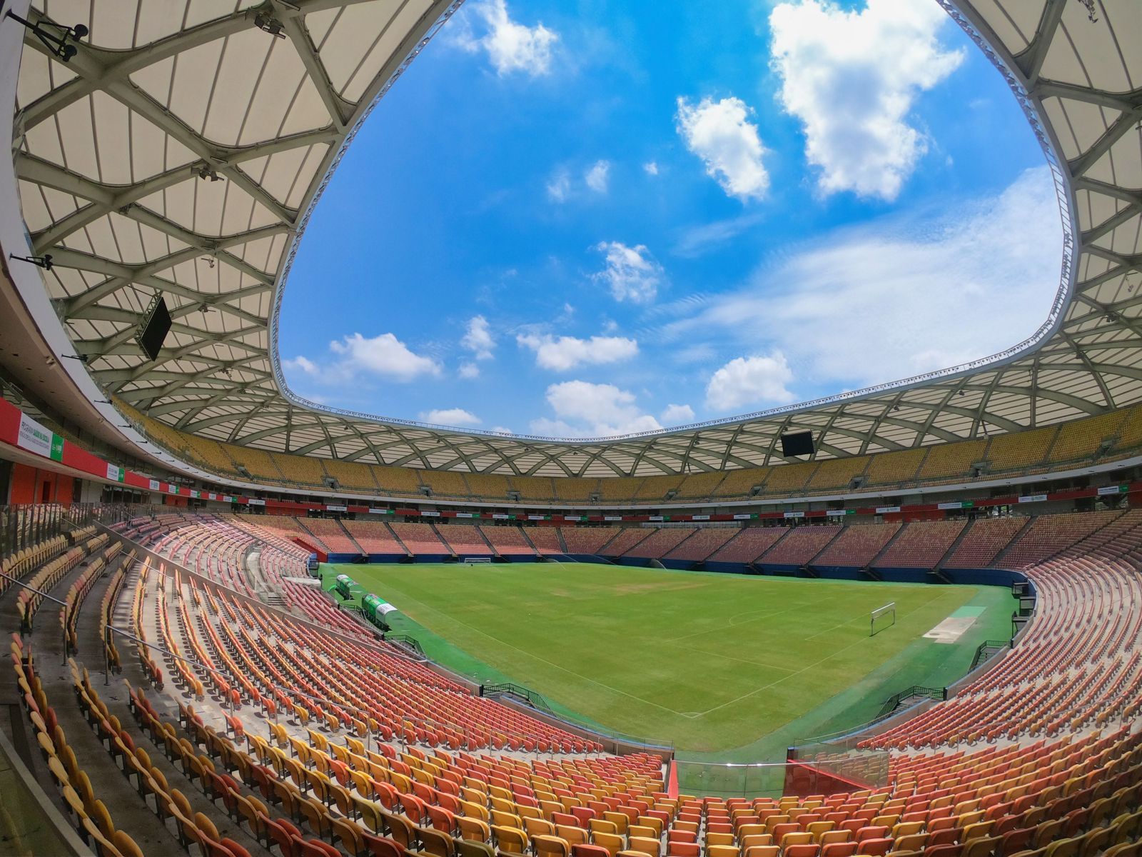 Wide view of an open stadium bowl under a blue sky